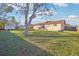 Expansive backyard with a lush green lawn, shed and patio area ideal for relaxation and entertainment at 1907 E Chapel Dr, Deltona, FL 32738