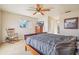 Bedroom featuring carpet floors, ceiling fan, wooden furniture and natural light from window at 1907 E Chapel Dr, Deltona, FL 32738