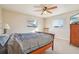 Bedroom with a ceiling fan, two windows, carpet floors, and a wooden dresser at 1907 E Chapel Dr, Deltona, FL 32738