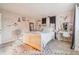 Bright bedroom featuring a cozy bed with white bedding, decor, a desk, and unique wall decor at 1907 E Chapel Dr, Deltona, FL 32738