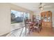 Bright dining area with a large sliding glass door, tile flooring, and a wooden dining set at 1907 E Chapel Dr, Deltona, FL 32738