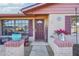 Inviting front entrance with a 'welcome' sign, decorative plants, and updated brick facade at 1907 E Chapel Dr, Deltona, FL 32738