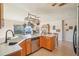 Kitchen featuring wooden cabinets, stainless steel appliances, and a sink with a view to the backyard at 1907 E Chapel Dr, Deltona, FL 32738