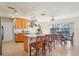 Bright kitchen featuring wood cabinets, island seating, stainless steel appliances, and sliding glass doors to the backyard at 1907 E Chapel Dr, Deltona, FL 32738