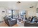 Cozy living room with leather sofas, neutral walls, and a large window bringing in natural light at 1907 E Chapel Dr, Deltona, FL 32738