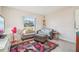Inviting living room with a comfortable seating, and plenty of natural light from the window at 1907 E Chapel Dr, Deltona, FL 32738