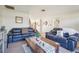 The living room features tile floors, black couches, an inviting decor and plenty of space at 1907 E Chapel Dr, Deltona, FL 32738