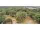 Aerial view showing property with a driveway and surrounding trees at 34620 Galla Rd, Fruitland Park, FL 34731