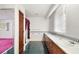 Bathroom with double sinks, oak vanity, and tile floor at 34620 Galla Rd, Fruitland Park, FL 34731