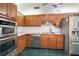 Kitchen with oak cabinets, stainless steel appliances, and tile floor at 34620 Galla Rd, Fruitland Park, FL 34731