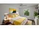 Bright bedroom with a sunny color scheme, light walls, ceiling fan, and a large window at 3550 Auburndale Ave, The Villages, FL 32162