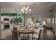 Open-concept living room with modern lighting and a dining area, seamlessly connecting the kitchen and creating a welcoming space at 3550 Auburndale Ave, The Villages, FL 32162