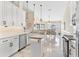 Open kitchen showcasing white cabinets, a kitchen island, and views into the dining area at 39320 Harbor Hills Blvd, Lady Lake, FL 32159