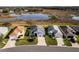 A neighborhood with well-maintained homes features a scenic water view, enhancing the community's appeal at 5717 Illumination Ln, Leesburg, FL 34748