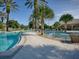 Spacious community pool area with palm trees and ample seating for residents and guests at 5717 Illumination Ln, Leesburg, FL 34748