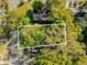 Aerial view of the property lot amid mature trees in a serene residential setting at Tbd E Jackson Ave, Mount Dora, FL 32757