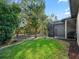 Landscaped backyard with screened porch and wooded backdrop at 10994 Se 168Th Loop, Summerfield, FL 34491