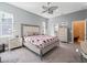 Bright bedroom featuring a king-size bed and ensuite bathroom access at 10994 Se 168Th Loop, Summerfield, FL 34491