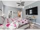 Large bedroom with king bed, large TV, and plenty of natural light at 10994 Se 168Th Loop, Summerfield, FL 34491