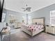 Spacious bedroom with large bed, ceiling fan, and ample natural light at 10994 Se 168Th Loop, Summerfield, FL 34491