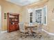 Cozy dining area with round table and wooden hutch at 10994 Se 168Th Loop, Summerfield, FL 34491