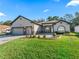 Two-story home showcasing a two-car garage and neat landscaping at 10994 Se 168Th Loop, Summerfield, FL 34491