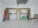 Spacious garage with overhead storage and additional shelving at 10994 Se 168Th Loop, Summerfield, FL 34491