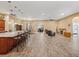 Open floor plan showing the kitchen with an island and granite countertops at 10994 Se 168Th Loop, Summerfield, FL 34491