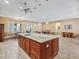Large kitchen island with granite countertop and wooden cabinets at 10994 Se 168Th Loop, Summerfield, FL 34491