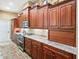 Well-equipped kitchen with wood cabinets and granite countertops at 10994 Se 168Th Loop, Summerfield, FL 34491