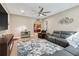 Open living room with sectional sofa and view into kitchen at 10994 Se 168Th Loop, Summerfield, FL 34491