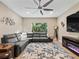 Spacious living room, featuring a sectional sofa and large TV at 10994 Se 168Th Loop, Summerfield, FL 34491