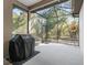 Spacious screened porch with built-in grill, overlooking a wooded area at 10994 Se 168Th Loop, Summerfield, FL 34491