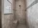 Spacious walk-in shower with built-in seat and modern tile at 10994 Se 168Th Loop, Summerfield, FL 34491