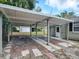 Covered brick carport with access to house and backyard at 1323 Liberty Ave, Mount Dora, FL 32757