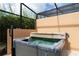 Hot tub on patio with screened enclosure at 2604 Roadster Ln, Kissimmee, FL 34746