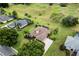 Stunning aerial view showcases the home's prime location backing onto the golf course, lush landscaping, and circular driveway at 39539 Harbor Hills Blvd, Lady Lake, FL 32159