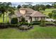 Gorgeous home featuring lush landscaping, manicured lawn, and a welcoming entrance at 39539 Harbor Hills Blvd, Lady Lake, FL 32159