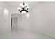 An open living room with all white floors and white walls, lit by recessed lights, with two alcoves at 39539 Harbor Hills Blvd, Lady Lake, FL 32159