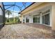 Expansive screened patio with brick flooring and ceiling fans, ideal for outdoor entertaining overlooking manicured backyard at 39539 Harbor Hills Blvd, Lady Lake, FL 32159