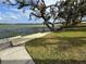 Lakeside backyard with an existing dock featuring grassy area leading to tranquil water views at 4060 Lake Marianna Dr, Winter Haven, FL 33881
