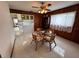 Dining area with wood-paneled walls and furnishings, offering a partial view of the kitchen and living spaces at 4060 Lake Marianna Dr, Winter Haven, FL 33881