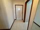 View of the home's entryway with light-colored tile flooring and a wooden framed door with a diamond-shaped window at 4060 Lake Marianna Dr, Winter Haven, FL 33881