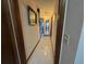 Bright hallway featuring tile floors and decorative wall art leading to other rooms at 4060 Lake Marianna Dr, Winter Haven, FL 33881