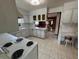 Bright kitchen featuring white cabinets, countertops, and marble-patterned tile flooring, along with a dining nook at 4060 Lake Marianna Dr, Winter Haven, FL 33881