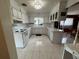 Bright kitchen featuring white cabinets, countertops, a window over the sink, and marble-patterned tile flooring at 4060 Lake Marianna Dr, Winter Haven, FL 33881