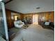 Cozy living room with paneled walls, neutral carpet, and plenty of space for relaxation at 4060 Lake Marianna Dr, Winter Haven, FL 33881