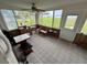 Charming sunroom with lots of natural light and a picturesque view of the backyard and lake at 4060 Lake Marianna Dr, Winter Haven, FL 33881