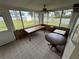 Bright sunroom featuring large windows, neutral carpet, and views of the spacious yard at 4060 Lake Marianna Dr, Winter Haven, FL 33881