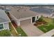 Aerial view of home with garage and landscaped yard at 537 Narrow View Ln, Groveland, FL 34736